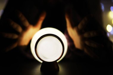 Yerde Bokeh 'le kristal küre var. Renkli ışık saçan cam top, yeni yıl kutlaması konsepti..