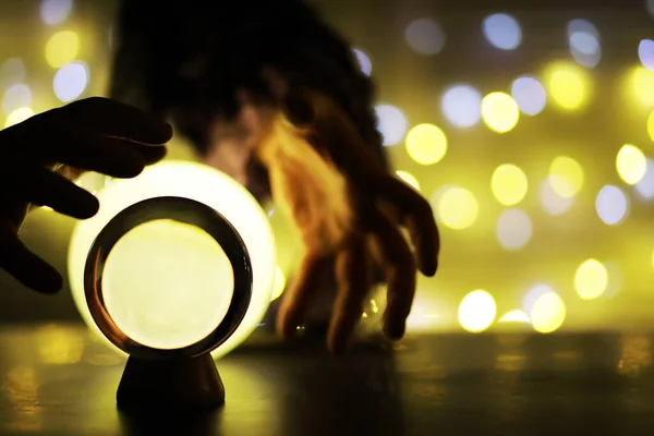 Crystal Ball on the floor with bokeh. Glass ball with colorful bokeh light, new year celebration concept.