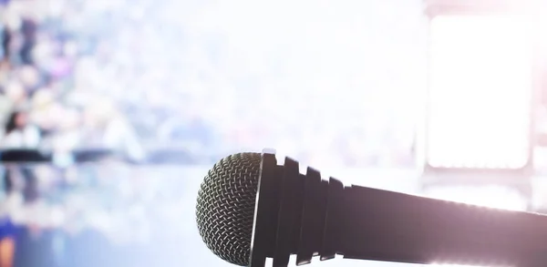 The microphone on the stage in front of the hall. Performance on stage. Rack for performances.