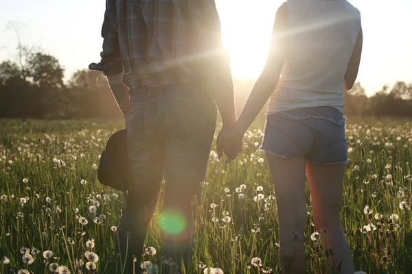 Cute couple on a walk by the countryside summer