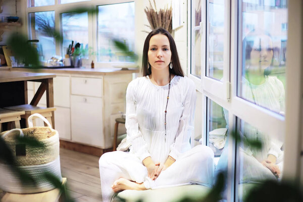 Beautiful athletic girl doing yoga exercises enjoy meditation at home. No stress, healthy habit, anxiety relief concept. Lotus.