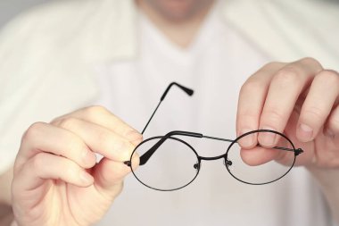 Kötü görüş kavramı. Kontak lens ve gözlüğü elinizde tutun. Reklam gözlükleri ve lensler için poster.