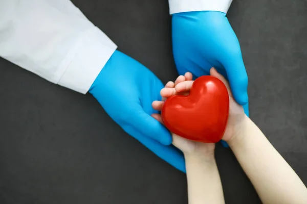 Medical concept. The doctor in gloves holds patient\'s hand. The moral help of the doctor to his patients. Cardiologist consultation. Epidemic.