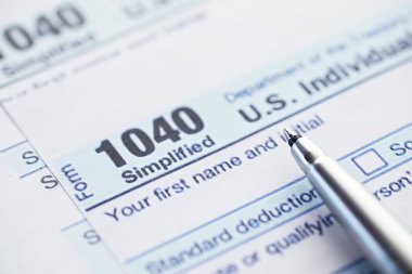 Yıllık vergi bildirimi. Masada vergi formu var. Finansal açıklamalar imzası.