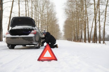 Adam ve araba. Kış yürüyüşü ve araba tamiri.