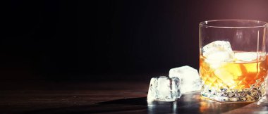 Tahta tezgahta buzlu sert bir alkollü içecek. Buzlu viski alayım. Bardakla soğuk bir içecek..