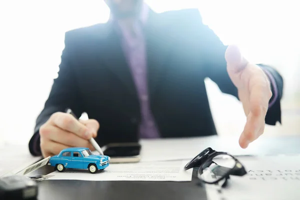 The insurance agent signs a document. Car insurance policy. Auto insurance policy. Forms registration of the contract.