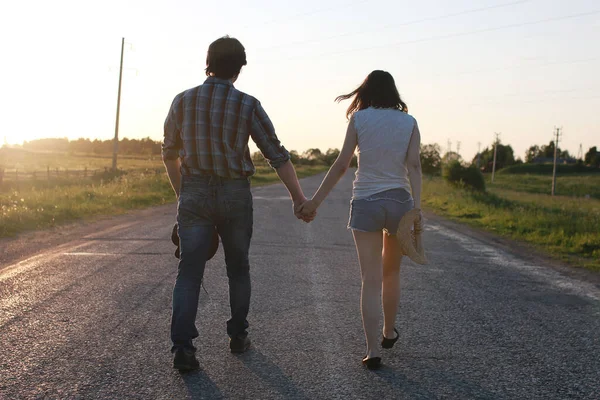 Cute couple on a walk by the countryside summer