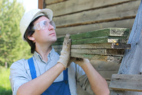 a man in the form of builder repairs a house