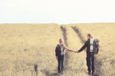 Sırt çantasıyla ve otostopla seyahat ediyor.