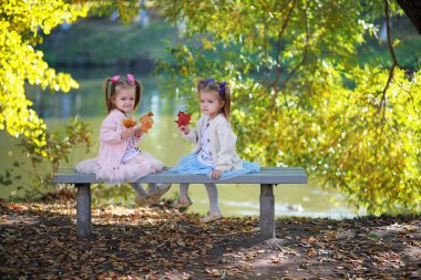 Yaprak parkta düşer. Sonbahar parkında yürüyüşe çıkmış çocuklar. - Aile. Düş! Mutluluk.