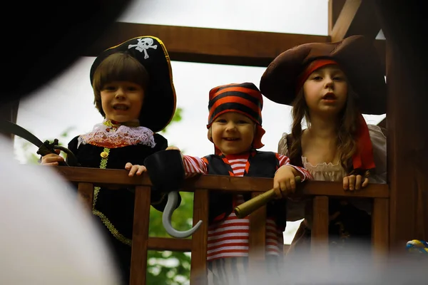 Children\'s party in pirate style. Children in pirate costumes are playing on Halloween.