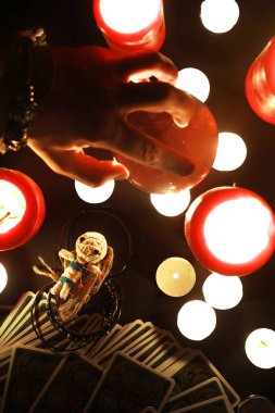 Büyülü bebeklerle, tarot kartlarıyla, kitaplarla, şeytani mumlarla ve cadılık objeleriyle dolu mistik bir hayat. Kehanet ayini.