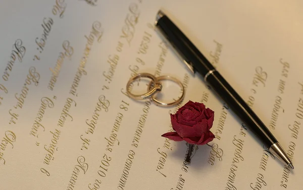 Bruiloft accessoires uitnodiging ringen roos en pen — Stockfoto