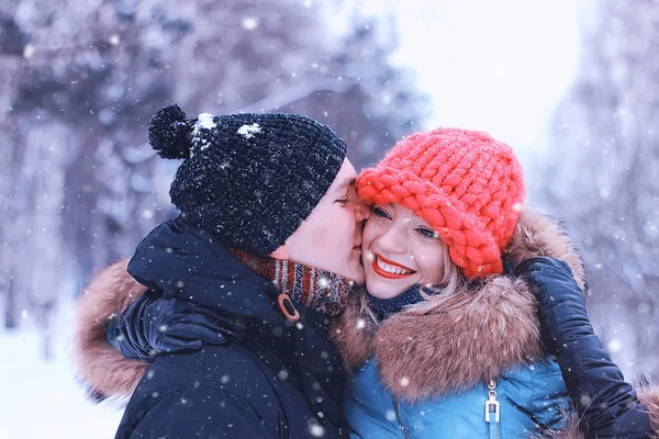 Man carries a girl young couple in winter — Stock Photo, Image