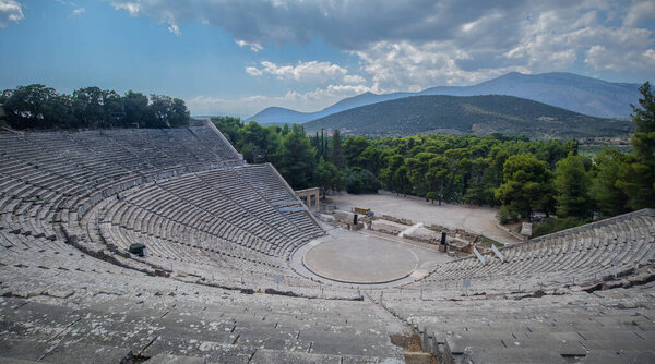 Panorama of the ancient theater of Epidaurus or Epidavros, Argolida prefecture, Peloponnese, Greece, viewed from the top downwards on a cloudy day.