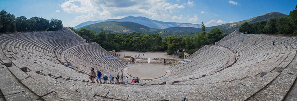 Panorama of the ancient theater of Epidaurus or Epidavros, Argolida prefecture, Peloponnese, Greece, viewed from the top downwards on a cloudy day.