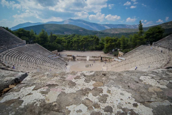 Panorama of the ancient theater of Epidaurus or Epidavros, Argolida prefecture, Peloponnese, Greece. Flat stone on top in focus, good for greek product placement