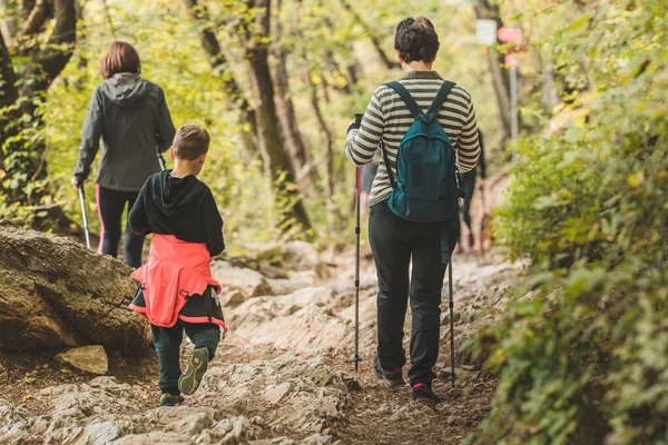 Older Woman Two Kids Descending Mountain Path Forest Group Using — Stock Photo, Image