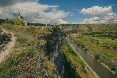 Güneşli bir yaz gününde Moldova 'daki Orheiul Vechi manastırındaki güzel kaya ve ağaç manzarası. Mağara manastırlarından birine doğru bakıyor..