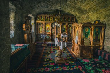 Interior of one of the cave monasteries in Orhei Vechi, close to Chuisinau, Moldova. Beautiful orthodox art and dwelling space clipart