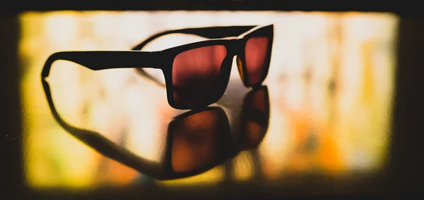 Old Vintage Sunglasses Sitting Reflective Surface Light Shining Them Reflecting — Stock Photo, Image