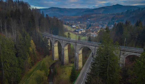 Magical aerial panorama of mystical Glebce viaduct close to Wisla, Poland in late autumn weather. Mysterious train bridge.