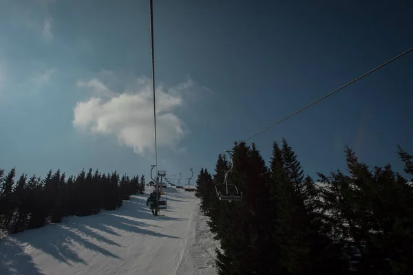 Old and worn gondola or ski lift on Soriska planina in slovenia on a sunny winter day.