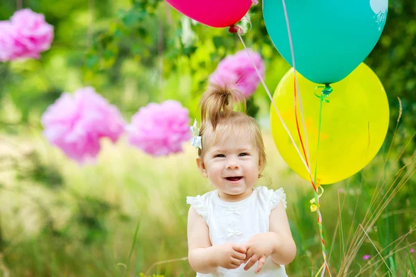 A little girl with balloons — Stock Photo, Image