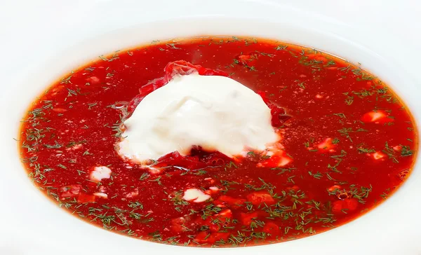 Soup with dill, pampushkas and sour cream on a white plate — Stock Photo, Image