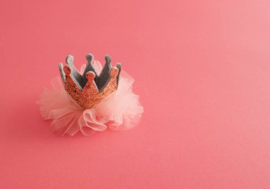 Golden crown on pink background. Concept for all princesses. clipart