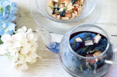 Bright blue color butterfly pea flower herb tea in a glass tea pot