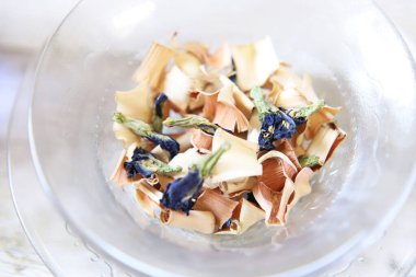 Butterfly pea flower and lemongrass dry herb tea in a glass dish