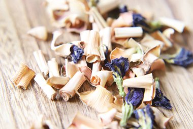 Butterfly pea flower and lemongrass dry herb tea on the wooden board