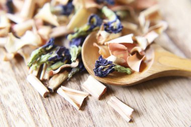 Butterfly pea flower and lemongrass dry herb tea on the wooden board