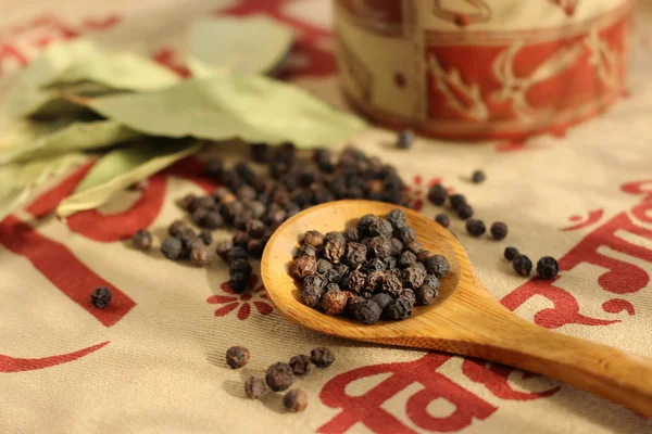 Black pepper seeds and bay leaves — Stock Photo, Image