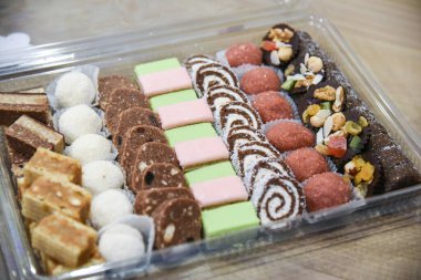 Rengarenk krema ve küçük kirazla süslenmiş renkli, nefis mini kekler.