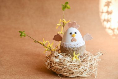 Güzel bir Paskalya süsü. Tavşanlar, tavuklar, yumurtalar, yuvalar, havuçlar, çiçekler ve ruh. Çiçekli salıncakta tavşan, anne tavuk ve yumurta. 