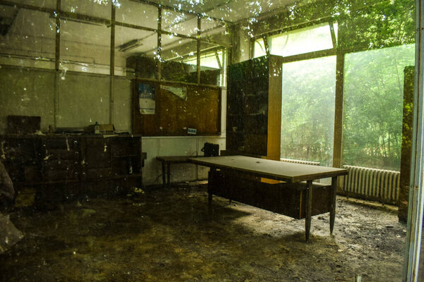 Old abandoned factory rooms and old machines. Rusty metal objects, dusty machines, broken things. Mud, cobweb moisture and mold. 