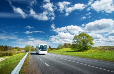 Bus on asphalt road in beautiful spring day clipart
