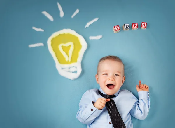 One year old boy and a bulb near. Child with an idea — Stock Photo, Image