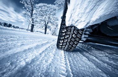 Car tires on winter road clipart