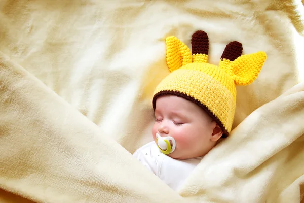 Baby sleeping in giraffe hat — Stock Photo, Image