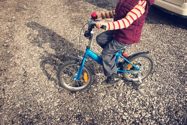 Boy on bike at gravel road — Stock Photo, Image