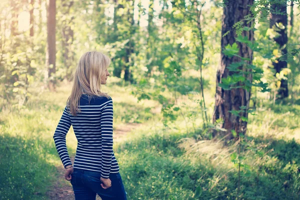 Woman in the forest on sunny summer day — Stock Photo, Image