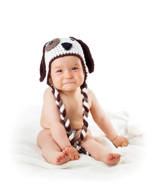 Sad baby in dog hat isolated on white background — Stock Photo, Image