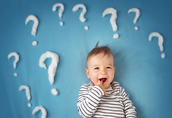 Funny little boy with lots of question marks — Stock Photo, Image