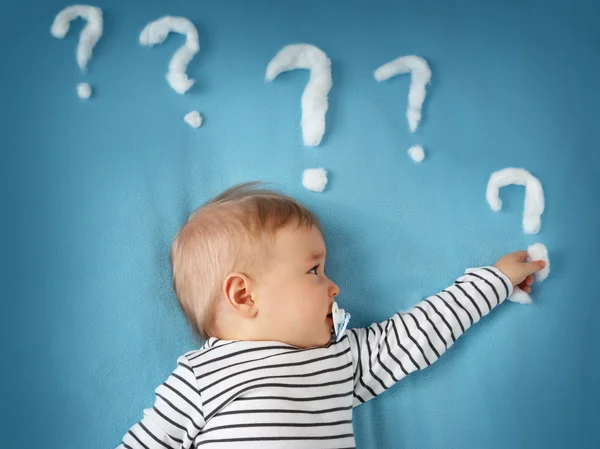 Funny little boy with lots of question marks — Stock Photo, Image