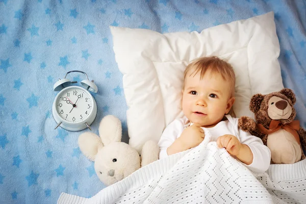 One year old baby with alarm clock — Stock Photo, Image