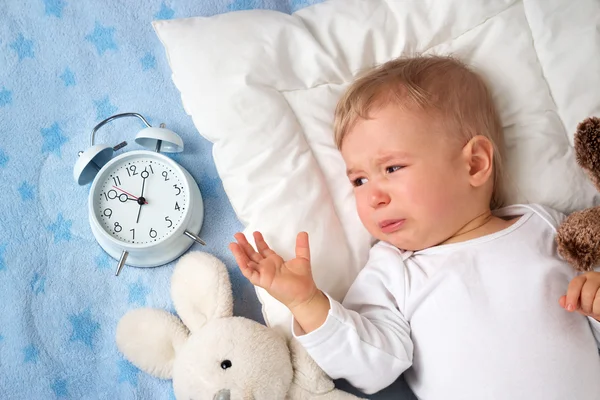 One year old baby with alarm clock — Stock Photo, Image